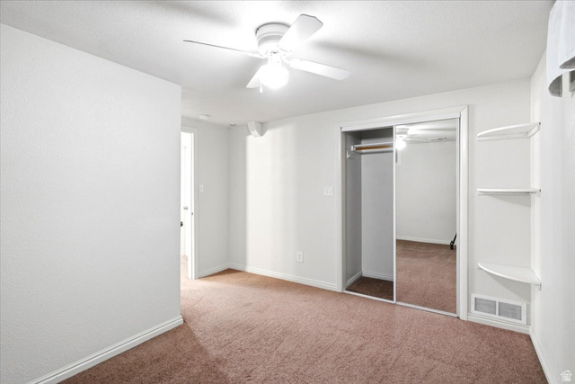 1341 29th Street Ogden, UT 84403 - Photo 25 of 37 Carpeted room featuring a ceiling fan, mirrored closet doors, and built-in shelving