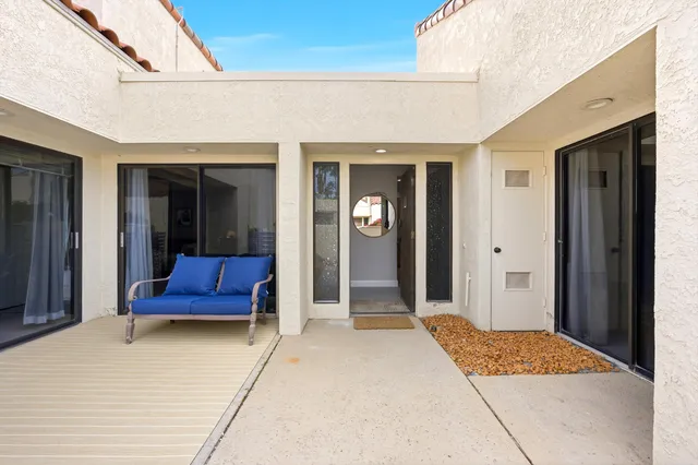 a bedroom with a bed and a potted plant