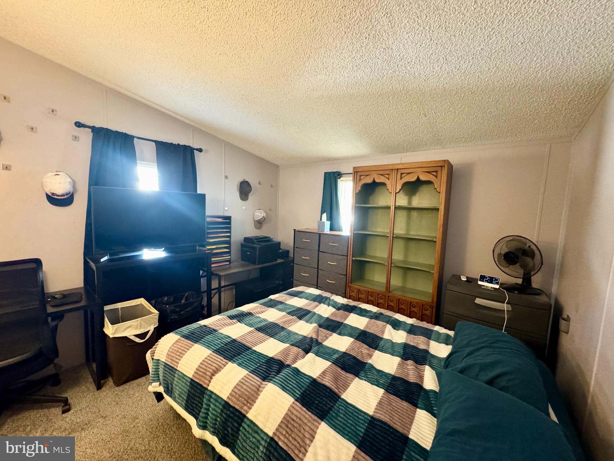 9333 Colonial Mill Drive Delmar, MD 21875 - Photo 12 of 31 a bedroom with a bed and a lamp on dresser