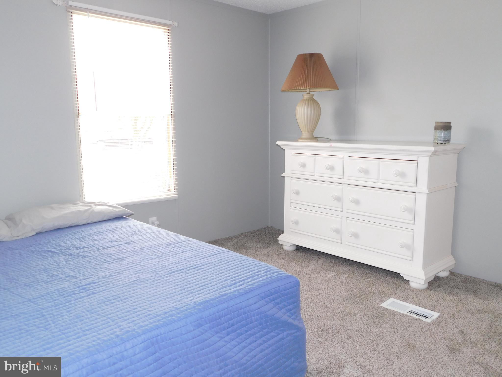9333 Colonial Mill Drive Delmar, MD 21875 - Photo 19 of 31 a bedroom with a bed and a dresser