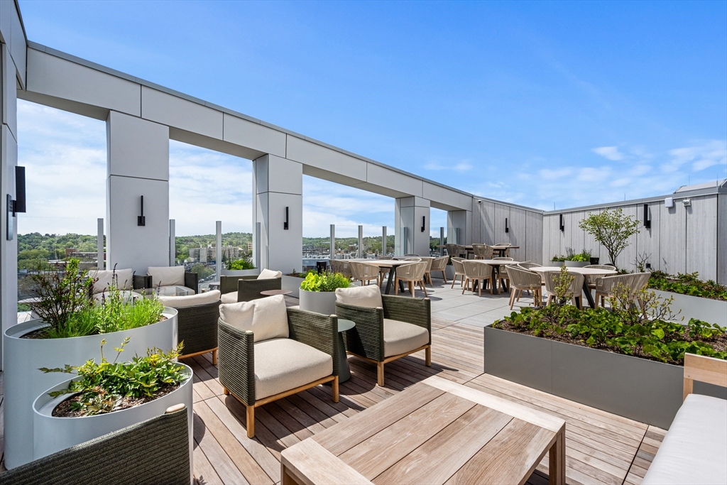 1515 Commonwealth Avenue, Unit 806 Boston, MA 02135 - Photo 21 of 21 a living room with furniture and a table