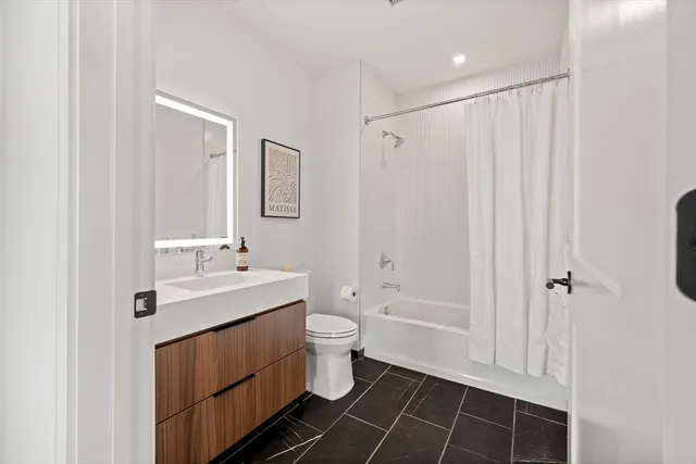 a bathroom with a sink toilet and shower