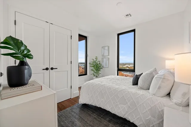 a bedroom with a bed and a potted plant