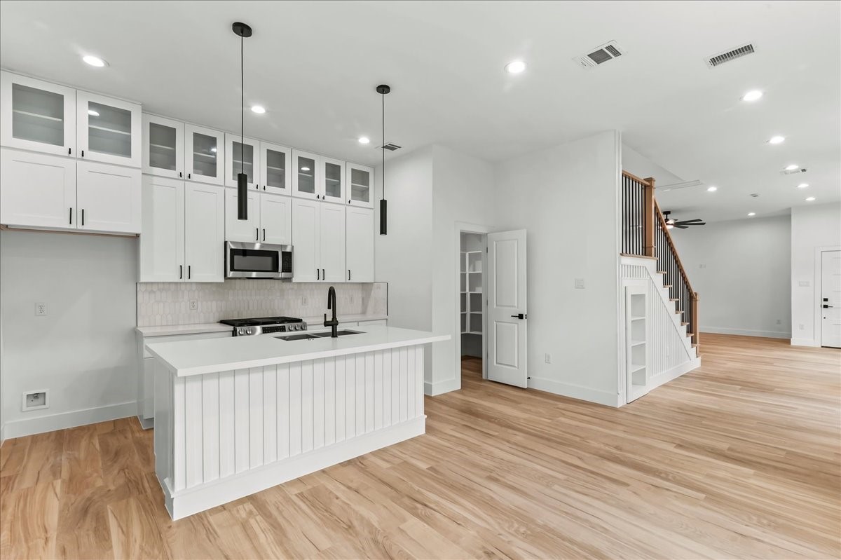 8323 Observatory Street, Unit A/B Houston, TX 77088 - Photo 21 of 38 Unit B - A chef’s paradise, this modern kitchen features double stacked cabinetry, stainless steel appliances, and luxurious quartz countertops. Ideal for cooking and entertaining. Design may vary. Pictures are from a previous build.