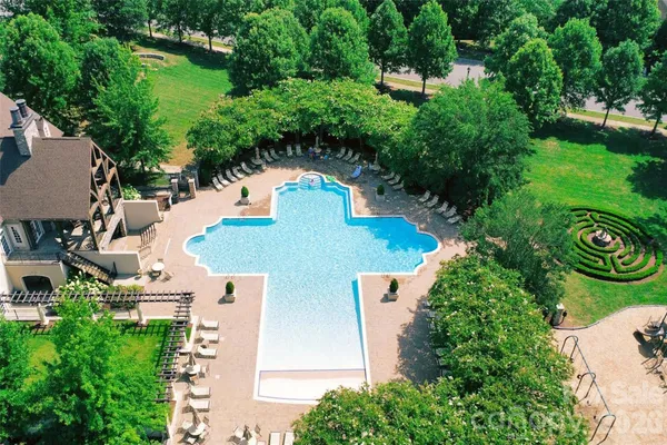 an aerial view of a house with outdoor space pool seating area and yard
