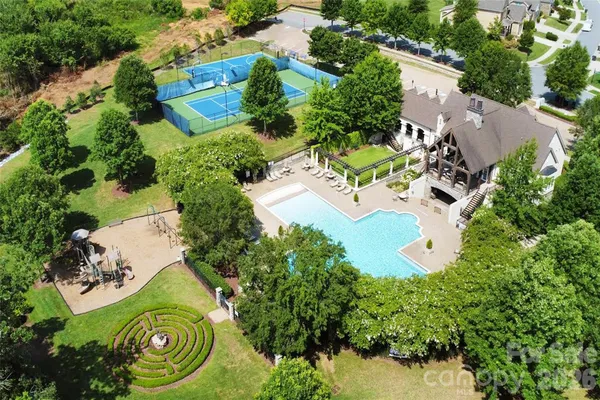 an aerial view of a house with a yard swimming pool and outdoor seating