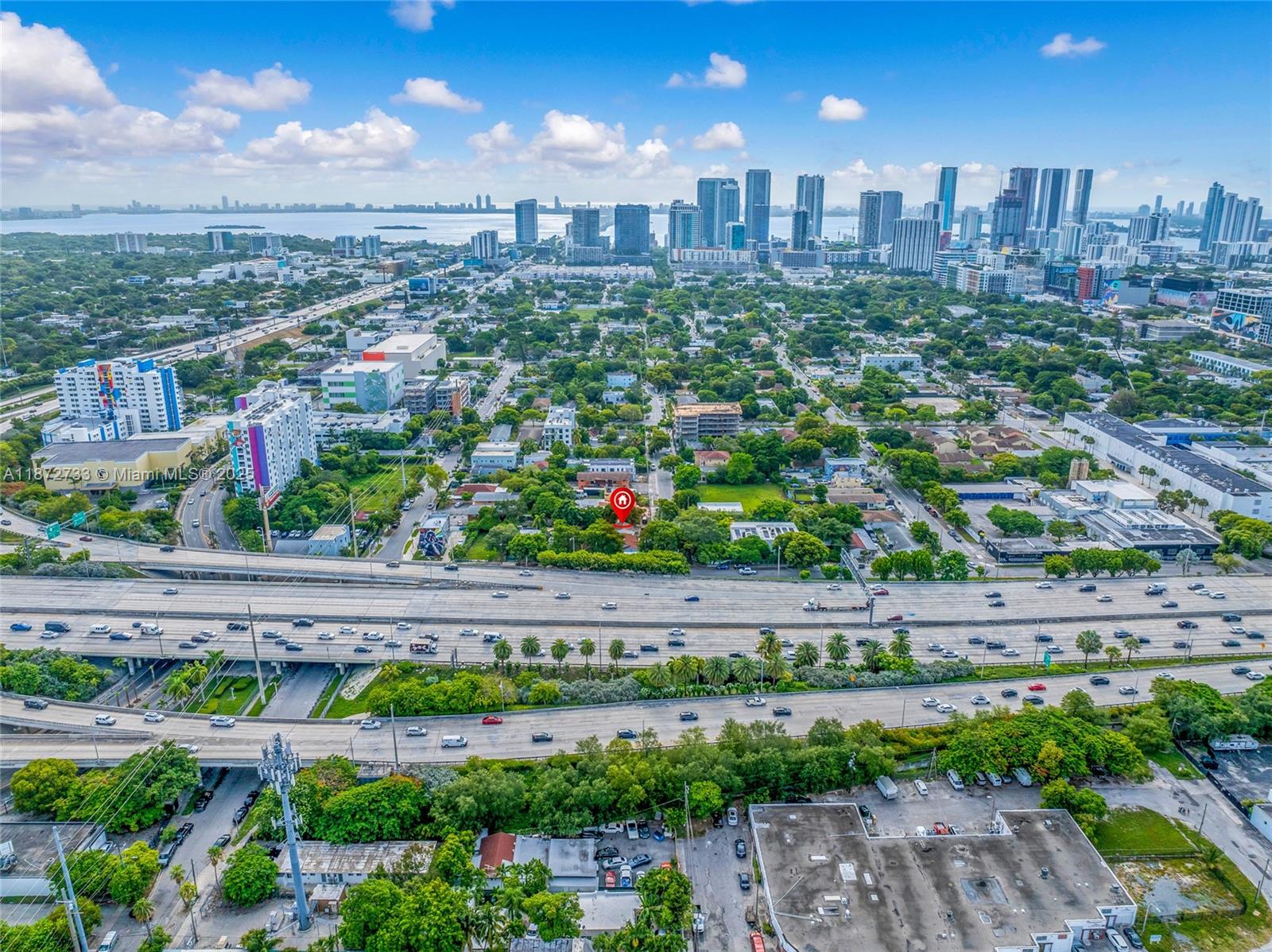 591 Northwest 34th Street Miami, FL 33127 - Photo 5 of 14 a view of a city with flower plants