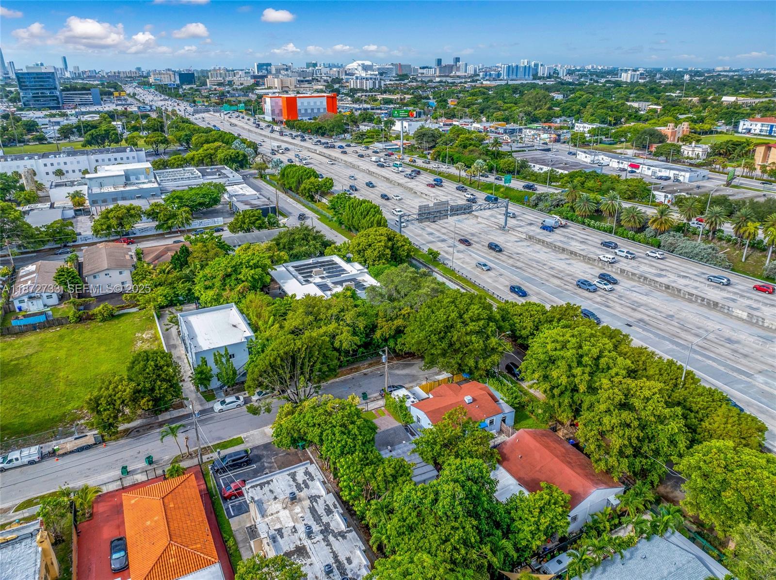 591 Northwest 34th Street Miami, FL 33127 - Photo 10 of 14 an aerial view of residential houses with outdoor space and trees