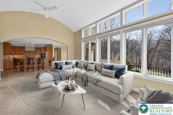 a living room with furniture a large window and table