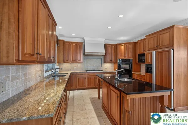 a kitchen with stainless steel appliances a refrigerator sink and cabinets