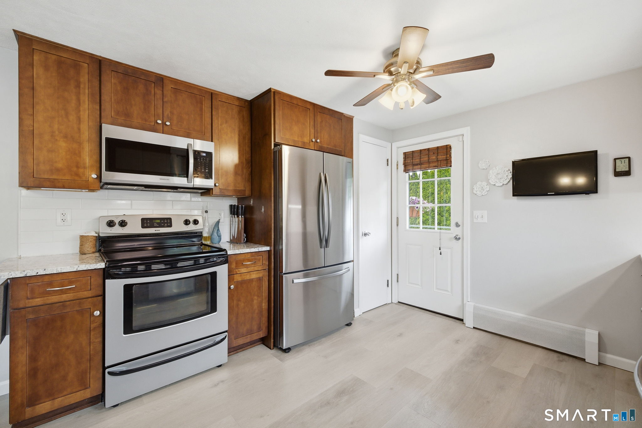 7 Stardust Drive Enfield, CT 06082 - Photo 10 of 38 a kitchen with stainless steel appliances a stove a microwave and a refrigerator
