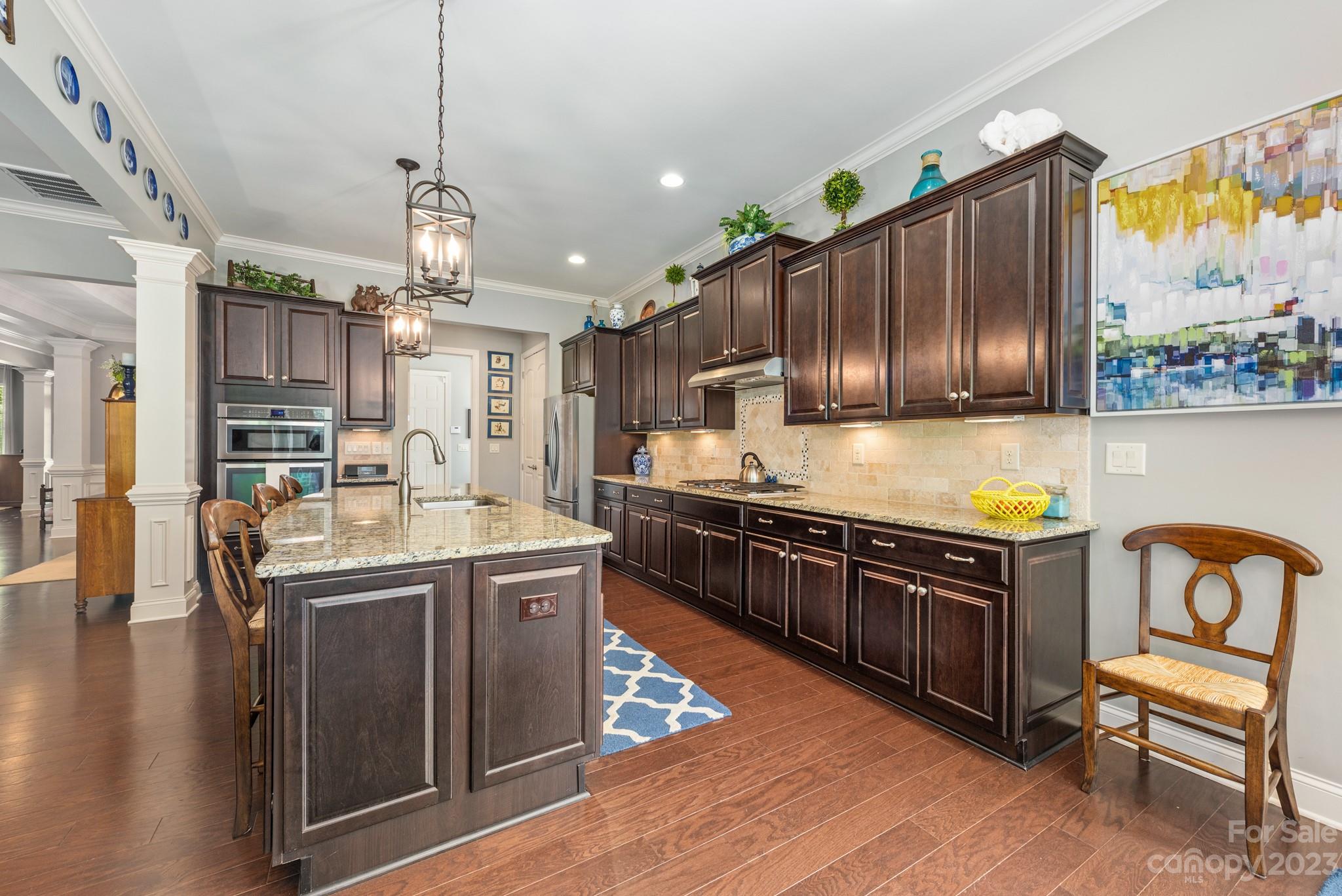 9006 Blue Ridge Drive Indian Land, SC 29707 - Photo 12 of 27 a kitchen with stainless steel appliances granite countertop a sink a stove and a wooden floors
