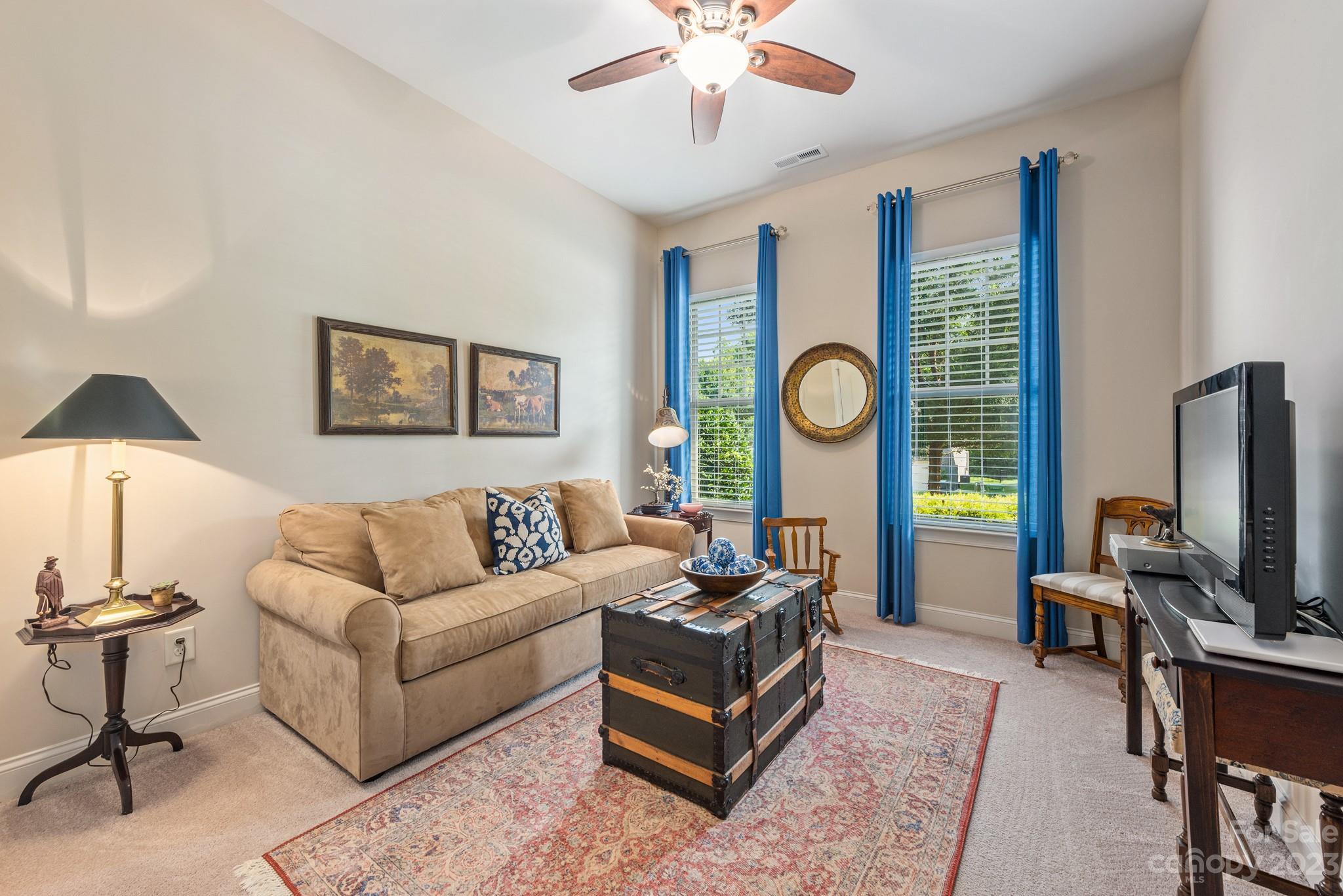 9006 Blue Ridge Drive Indian Land, SC 29707 - Photo 18 of 27 a living room with furniture a chandelier and a flat screen tv