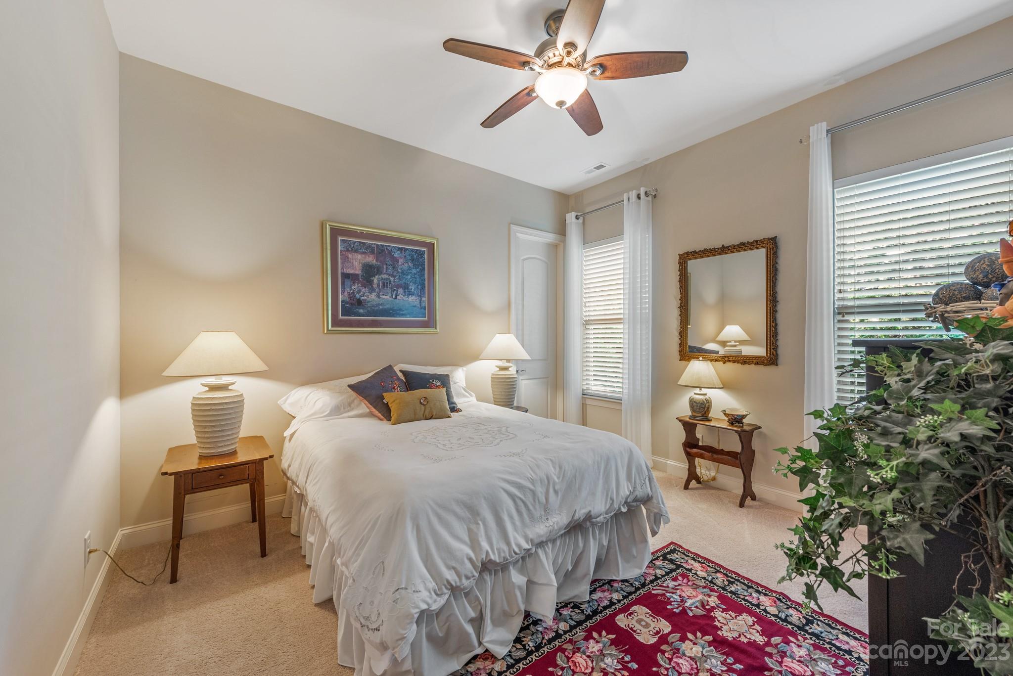 9006 Blue Ridge Drive Indian Land, SC 29707 - Photo 19 of 27 a bedroom with a bed and a chandelier