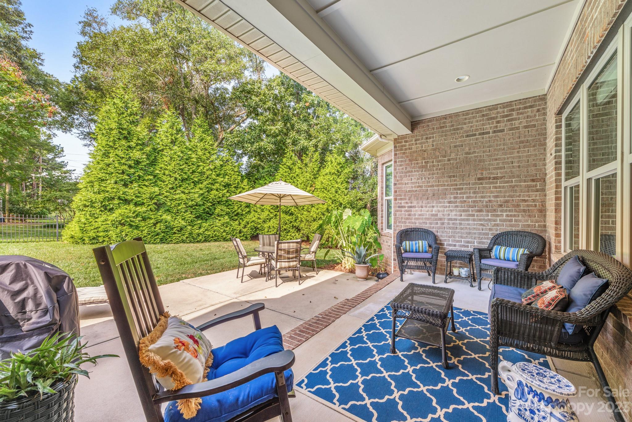 9006 Blue Ridge Drive Indian Land, SC 29707 - Photo 22 of 27 a view of a patio with a dining table and chairs