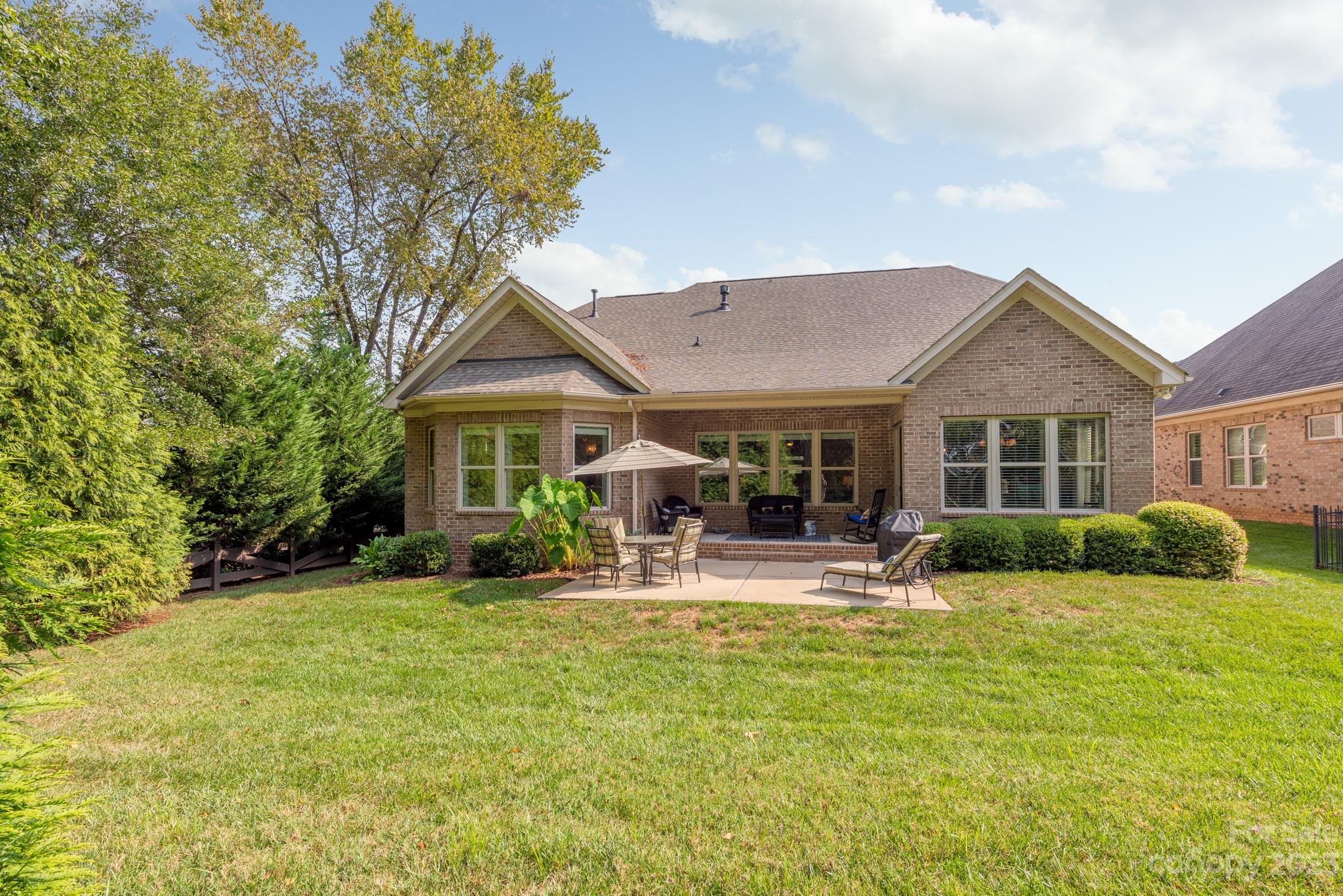9006 Blue Ridge Drive Indian Land, SC 29707 - Photo 23 of 27 a front view of a house with a yard table and chairs