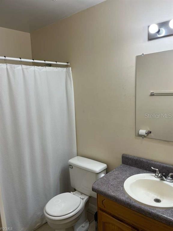 22278 Vick Street, Unit A112 Punta Gorda, FL 33980 - Photo 11 of 33 a bathroom with a sink a toilet and a mirror