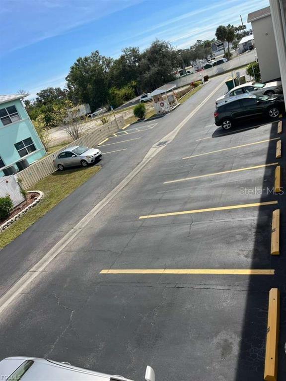22278 Vick Street, Unit A112 Punta Gorda, FL 33980 - Photo 3 of 33 a view of a city street with a car parked on the road