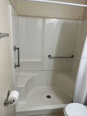 a bathroom with a shower and toilet