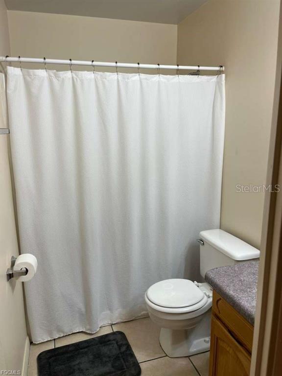 22278 Vick Street, Unit A112 Punta Gorda, FL 33980 - Photo 9 of 33 a white toilet sitting next to a shower curtain