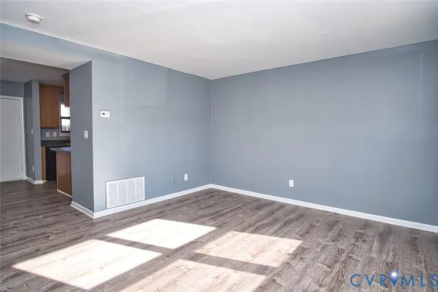 a kitchen with stainless steel appliances granite countertop a stove and a wooden floors