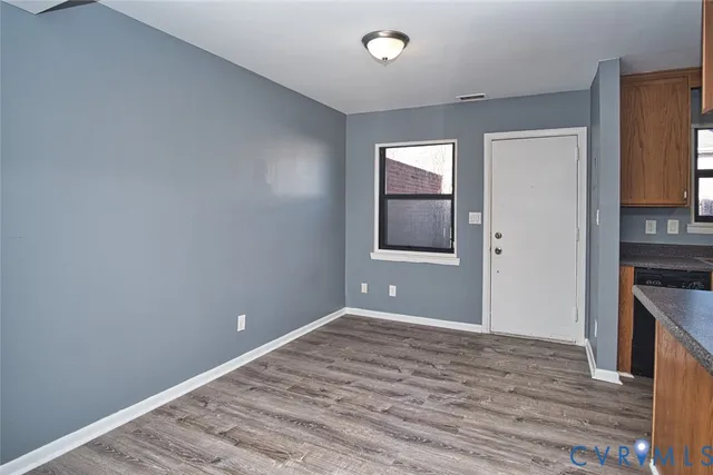 a kitchen with granite countertop wooden floors and a sink