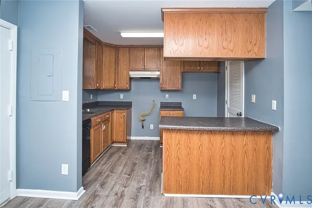 a kitchen with granite countertop wooden cabinets and a sink