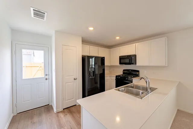 a kitchen with a refrigerator stove and microwave