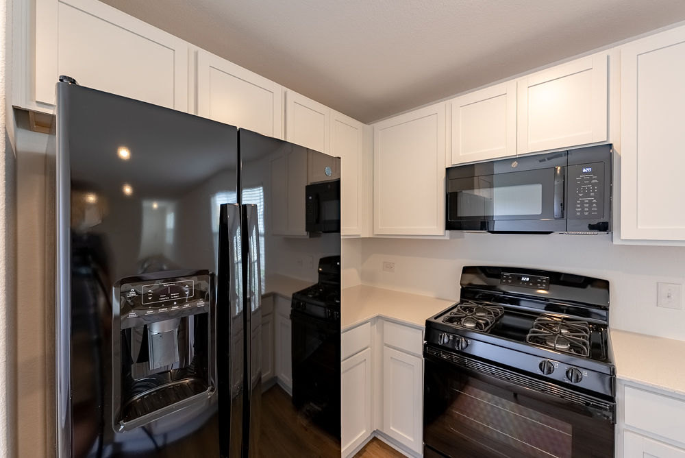 126 Avre Loop Kyle, TX 78640 - Photo 11 of 19 a kitchen with a refrigerator stove and microwave