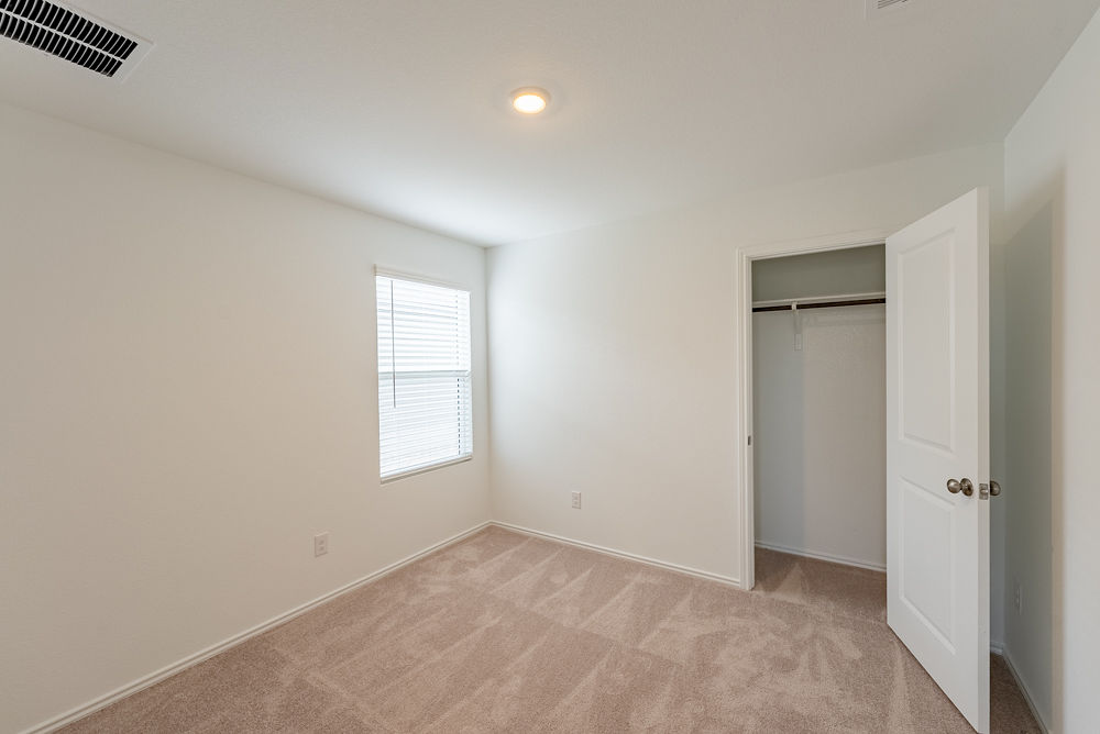 126 Avre Loop Kyle, TX 78640 - Photo 15 of 20 an empty room with windows and closet