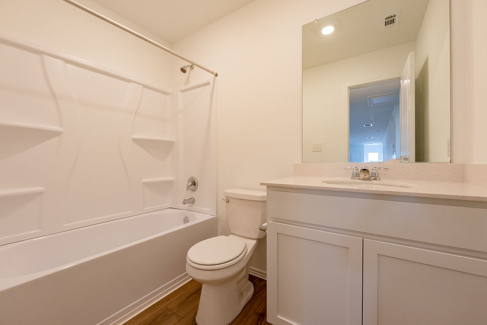 126 Avre Loop Kyle, TX 78640 - Photo 17 of 20 a bathroom with a sink a toilet and shower
