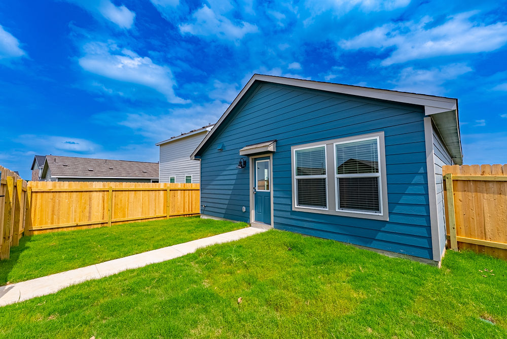 126 Avre Loop Kyle, TX 78640 - Photo 19 of 20 a view of a backyard with a garden