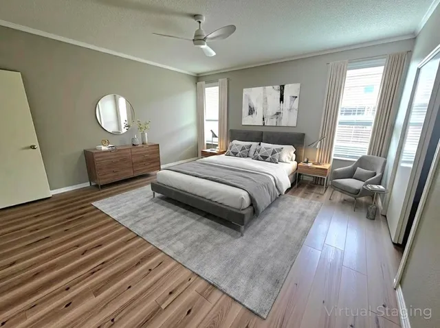 a bedroom with a bed and wooden floor