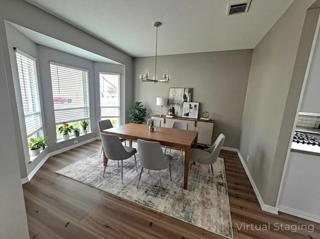 a dining room with furniture and wooden floor