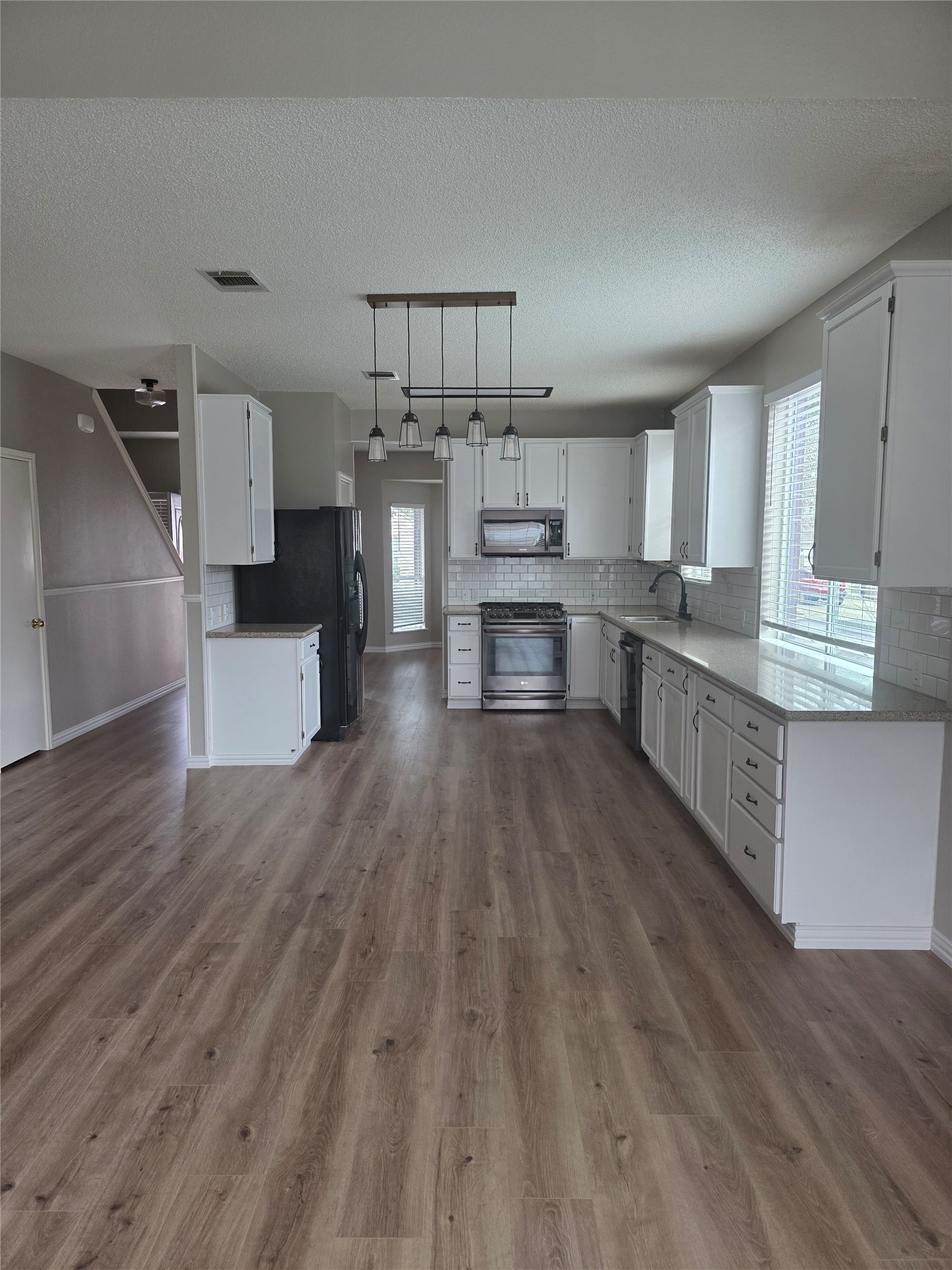 8507 Chat Lane Round Rock, TX 78681 - Photo 10 of 12 a kitchen with stainless steel appliances a lot of counter top space and cabinets