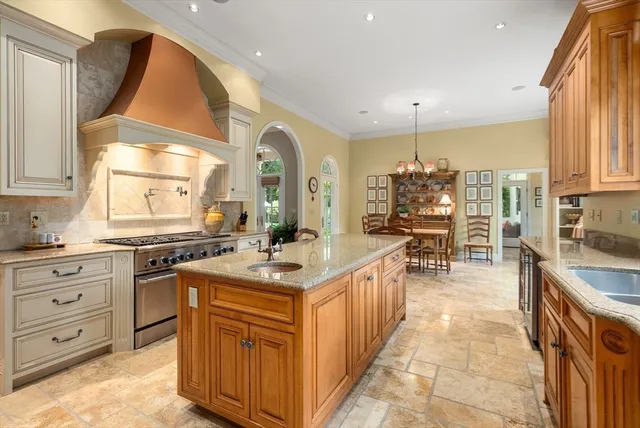 a kitchen with sink stove and cabinets