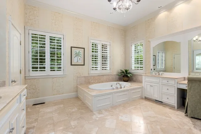 a spacious bathroom with a tub sink and mirror