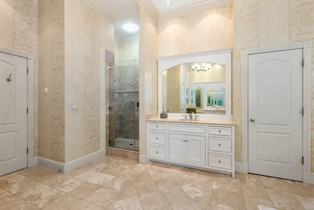 a spacious bathroom with a mirror sink and shower