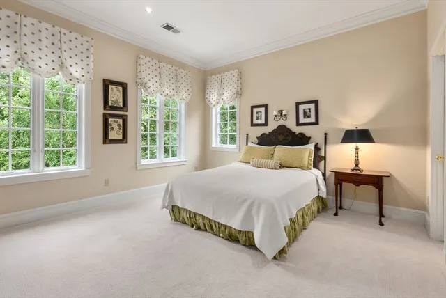 a spacious bedroom with a bed and a large window