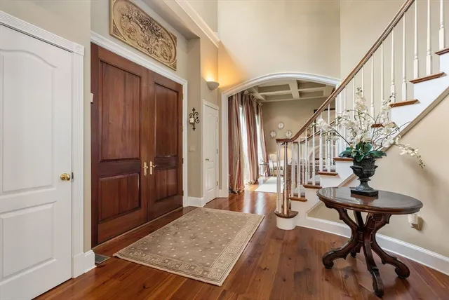 a view of a hallway with furniture and wooden floor