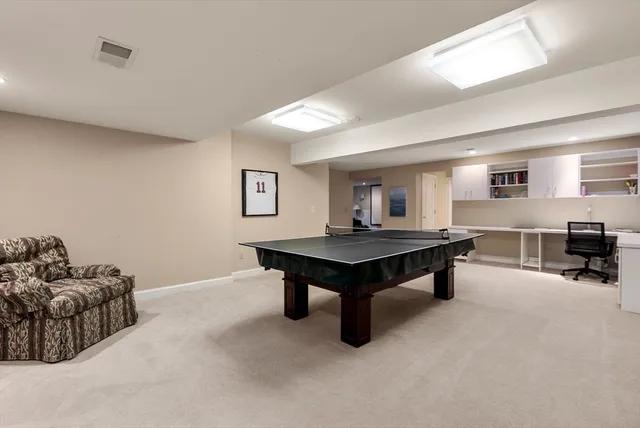 a living room with furniture and a dining table with rug floor