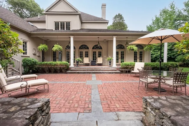 a view of a house with backyard sitting area and porch