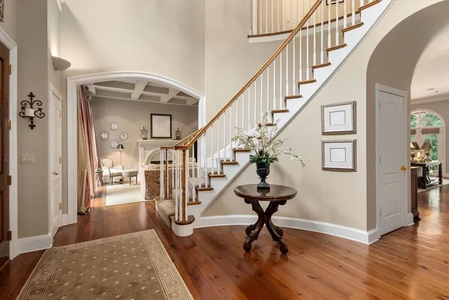 a view of entryway and hall with wooden floor