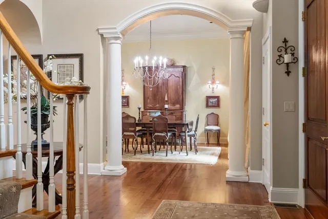 a view of a livingroom kitchen and dinning room with wooden floor