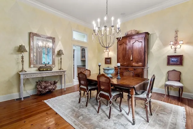 a view of a dining room with furniture and chandelier