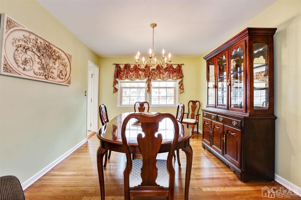 6 Huntington Road Edison, NJ 08820 - Photo 11 of 23 a view of a dining room with furniture wooden floor and chandelier