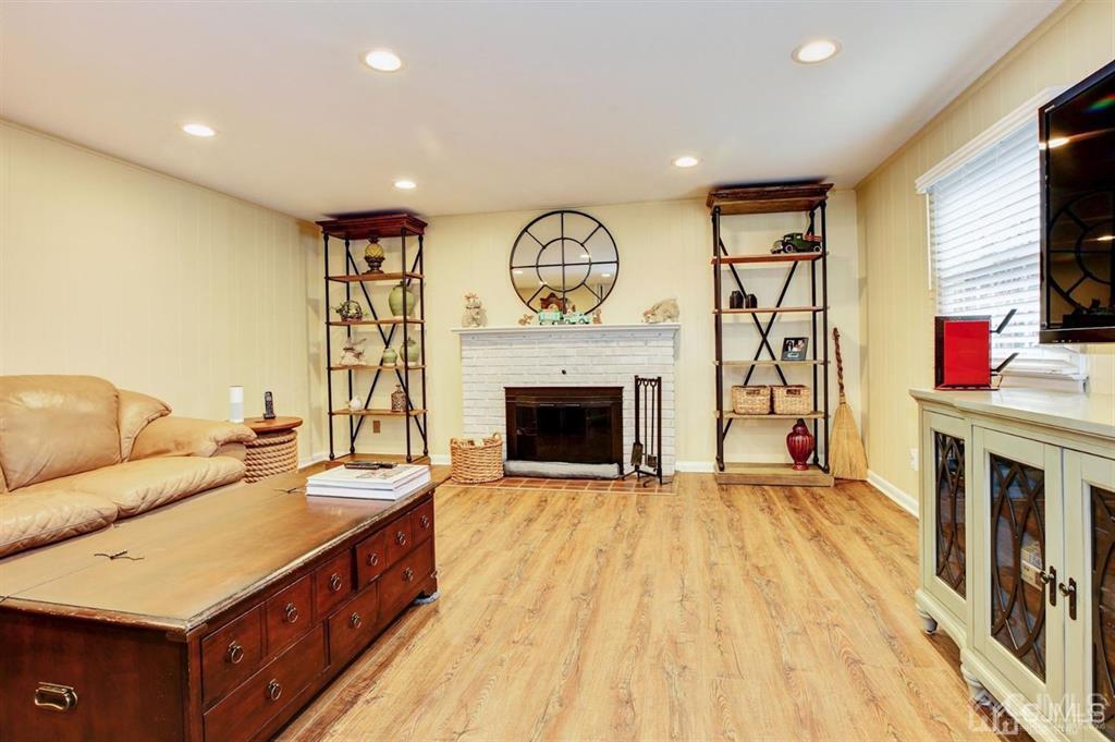 6 Huntington Road Edison, NJ 08820 - Photo 16 of 23 a living room with furniture a fireplace and a flat screen tv
