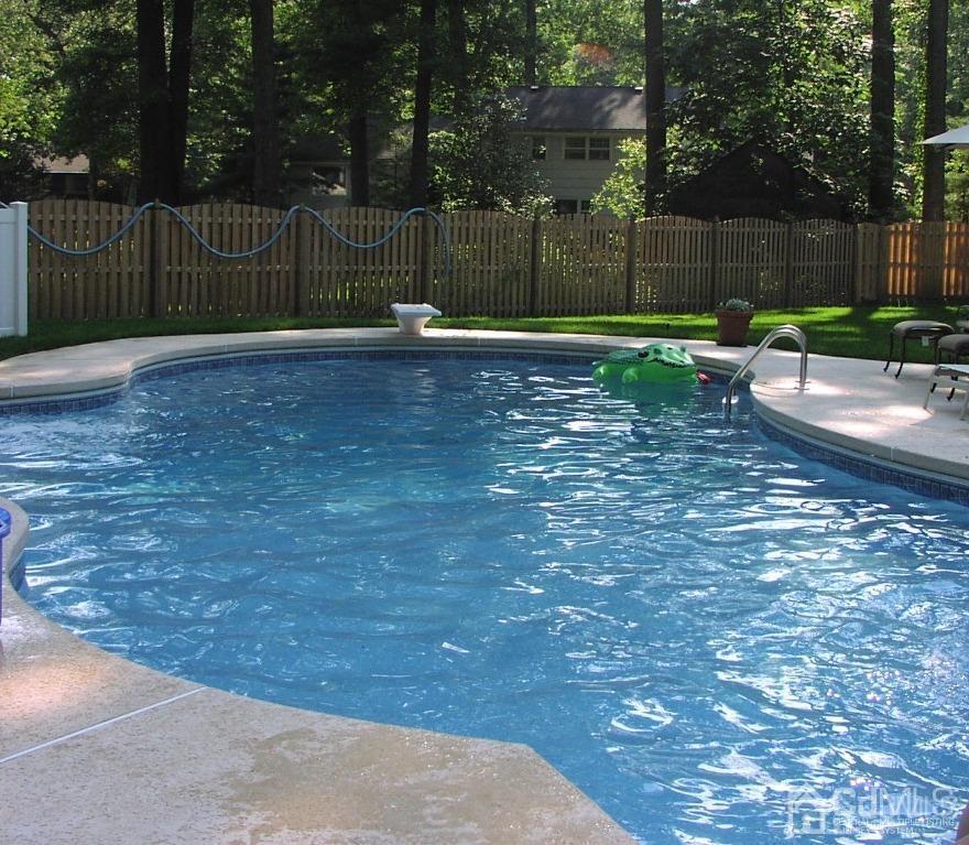 6 Huntington Road Edison, NJ 08820 - Photo 22 of 23 a view of a backyard with wooden fence