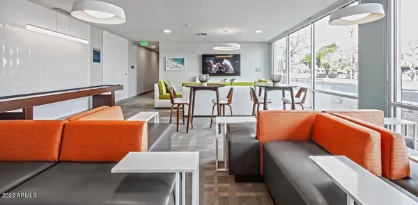 a kitchen with a dining table chairs cabinets and stainless steel appliances