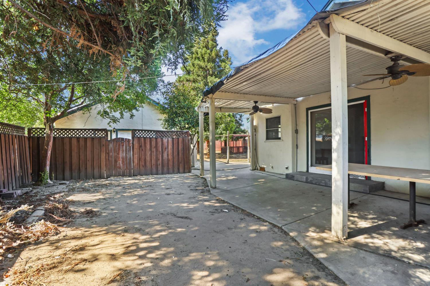 916 Elm Avenue Modesto, CA 95351 - Photo 34 of 52 Covered patio and fenced yard area show privacy, separation, and useful outdoor space for the two-dwelling layout.